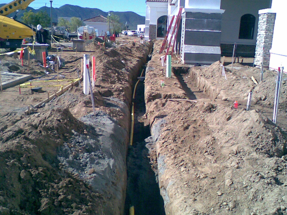 Underground utility trench with new water line installed by Superior West Plumbing